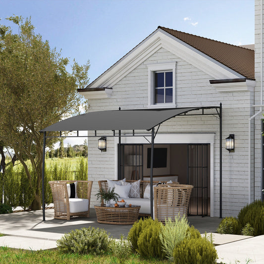 Outdoor patio area with a pergola and furniture in front of a house.