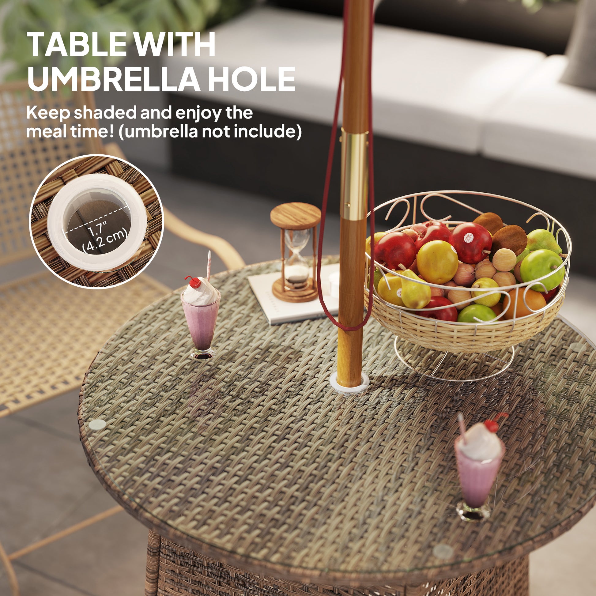 Round wicker table with umbrella hole, fruit basket, and drinks on a patio setting.