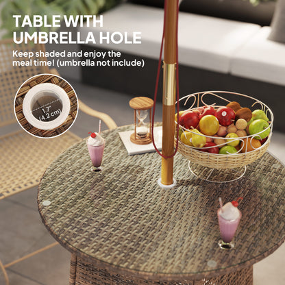 Round wicker table with umbrella hole, fruit basket, and drinks on a patio setting.